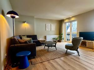 a living room with a couch and a table at Berghaus Wanderlust in Mallnitz