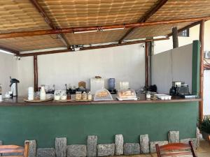 a kitchen with a counter with food on it at BRKITE Pousada in Cumbuco