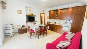 a living room with a red couch and a table at Appartamento da Mery in Asso +5 photos