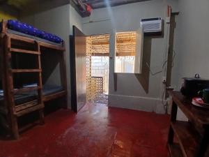 a room with two bunk beds and a window at Sunset View Guest House in Camiguin