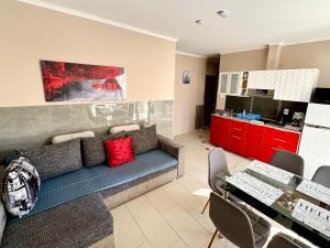 a living room with a couch and a kitchen at Dorina wellness in Siófok