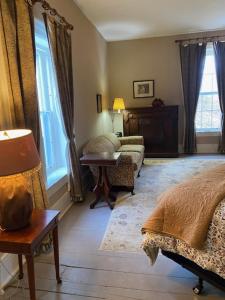 a living room with a bed and a couch at Black Sheep Inn in Hammondsport