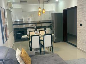 a kitchen with a table and chairs in a room at House Lima in Lobito +4 photos
