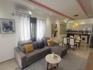a living room with a couch and a table at House Lima in Lobito