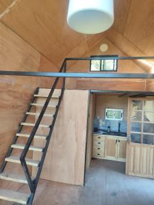 a spiral staircase in a tiny house at Cabañita para 2 in Villa Serrana