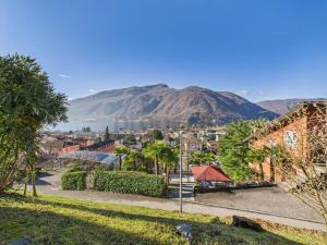 a view of a city with mountains in the background at La fornace lago in Melano