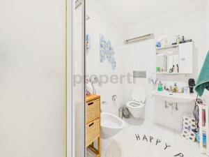 a white bathroom with a toilet and a sink at La fornace lago in Melano