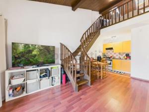 a living room with a staircase and a dining room at La fornace lago in Melano