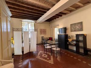 a living room with a table and a kitchen at La Castellana in Bergamo