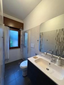 a bathroom with a sink and a toilet and a shower at L'angolo di Alice -Fronte ospedale- in Udine +4 photos