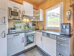 a kitchen with white cabinets and a window at Chalet in Hohentauern am Skilift in Hohentauern
