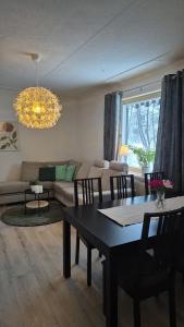 a living room with a table and a couch at RåneVillan in Råneå