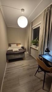 a bedroom with a bed and a desk and a window at RåneVillan in Råneå