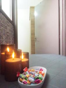 a bowl of candies and a candle and a bowl of candy at Budget Friendly -Private Room in a Moroccan Home - Host On Site in Agadir