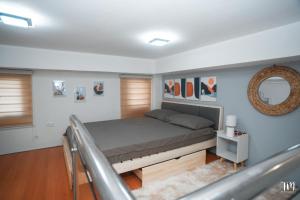 a bedroom with a bed and a mirror at Woodlands Condotel in Bulan +77 photos