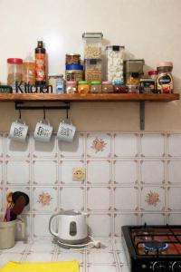 a kitchen with a shelf on the wall at Budget Friendly -Private Room in a Moroccan Home - Host On Site in Agadir