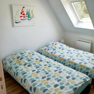 a bedroom with two beds with sails on the wall at Gite Les Sables Blancs in Plobannalec-Lesconil +5 photos