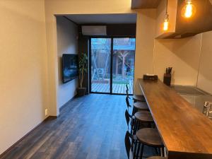 a dining room with a long wooden table and chairs at Biwako Villa 縁 in Takashima