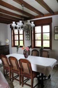 a dining room with a white table and chairs at Ons Heerens Boompje in Poperinge
