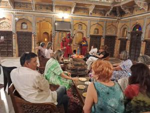 a group of people sitting around a table in a room at Hotel Radhika Haveli, Mandawa in Mandāwa +82 photos