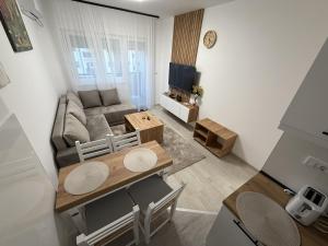 a living room with a couch and a table at Apartmani Fontana Banja Koviljaca in Banja Koviljača +20 photos