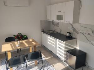 a kitchen with a table and a table and chairs at Apartment D&E in Sarajevo