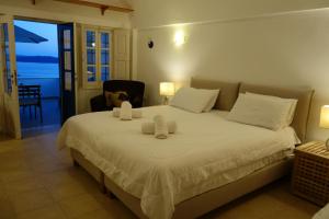 a bedroom with a large white bed with two pillows at Top Oia in Oia