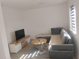 a living room with a couch and a table at Apartment D&E in Sarajevo