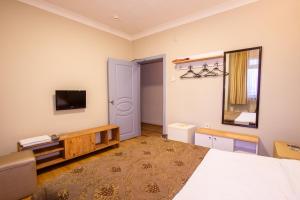 a bedroom with a bed and a tv on the wall at Tac Hotel in Ankara