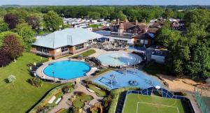 an aerial view of a house with two swimming pools at Rowan 42 in New Milton