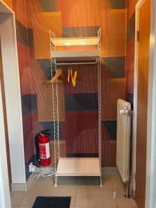 a walk in closet with a red fire extinguisher at Örkelljunga overnight stay in Orkelljunga