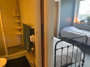 a small room with a bed and a mirror at Örkelljunga overnight stay in Orkelljunga