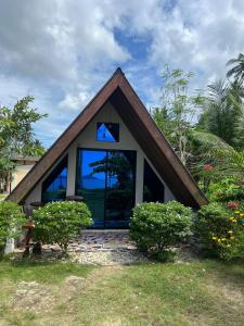 a small house with a triangular roof and large windows at Villa Fria private beach cottage in San Vicente