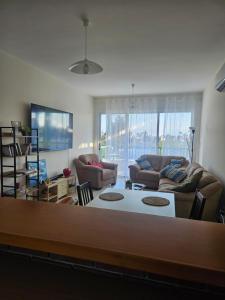 a living room with a couch and a table at Quiet 61 Perivolia in Meneou