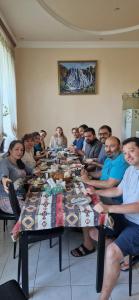 a group of people sitting around a long table at DINA in Sisian +28 photos