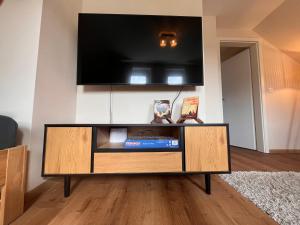 a entertainment center with a flat screen tv on a wall at Caspar-David-Friedrich in Königstein an der Elbe +17 photos