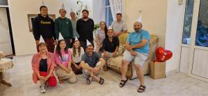 a group of people posing for a picture in a living room at DINA in Sisian