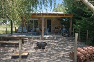 a patio with a table and a fire pit at Finca Santiago in San Miguel del Monte