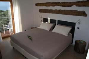 a bedroom with a large bed and a balcony at Guesthouse Grand View in Malcesine +84 photos