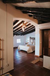a bedroom with a bed in the middle of a room at Casa de la Cueva in Figueroles