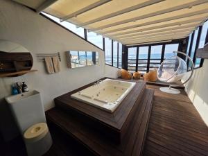 a bathroom with a tub in the middle of a room at Farms Village in Jeju