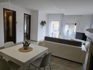 a living room with a couch and a table and chairs at Cannella Comfort Apartment in Bellagio