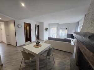 a living room with a table and a couch at Cannella Comfort Apartment in Bellagio