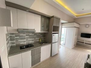 a kitchen with white cabinets and a counter top at Casa De Parco Apartment Max 4 Guests in Samporo