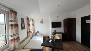 a living room with a couch and a table at Hotel Wuelfers Gasthaus in Groß Ippener