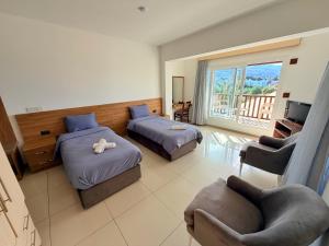 a hotel room with two beds and a balcony at The Horse Farm Hotel in Kyrenia +27 photos