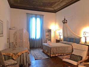 a bedroom with two beds and a large window at Florence Dream Domus in Florence