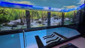 a display case with a painting of a waterfall at Hotel Marton in Koszalin