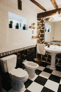 a bathroom with a toilet and a sink at Casa de la Cueva in Figueroles +58 photos