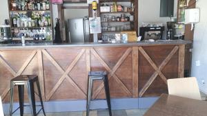 a wooden bar in a restaurant with two stools at Rest'ô Bar Les 2 Ponts in Saint-Simon +5 photos